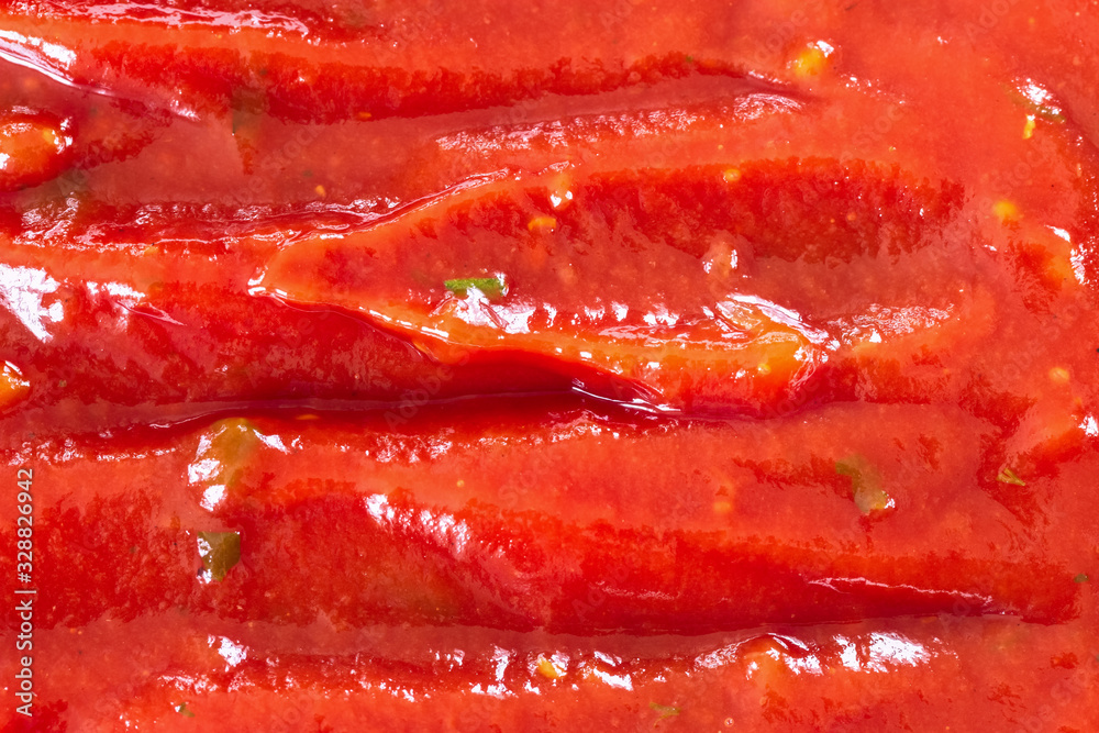 background with ketchup (filling in the picture). the texture of ketchup with some greenery.