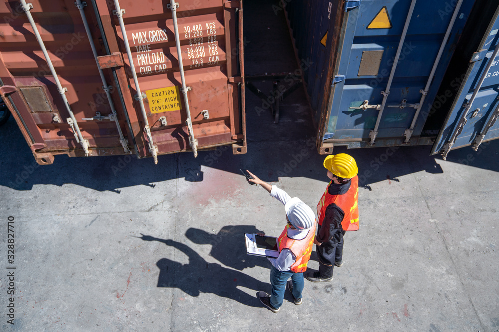 Logistics engineer control at the port, loading containers for trucks ...