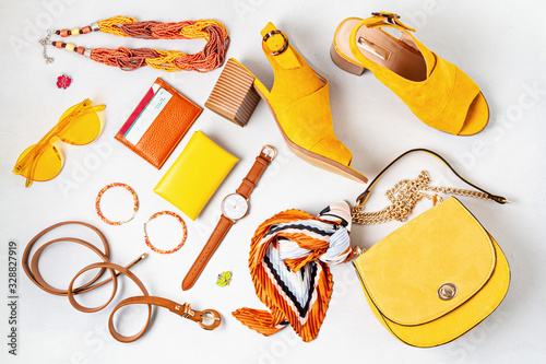 Flat lay with woman fashion accessories in yellow colors. Fashion, online beauty blog, summer style, shopping and trends idea photo