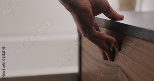 man hand open and close batroom cabinet drawer closeup