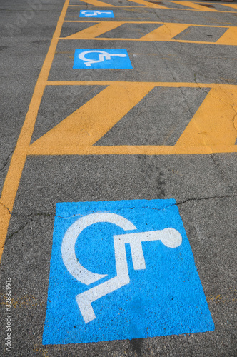blue and white signs indicating a parking for disabled people
