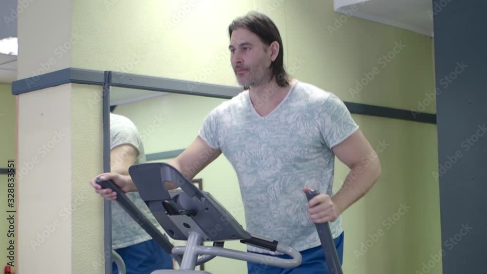 Middle aged man in gym. Cardio workout. Middle aged man in gym. Cardio workout.
