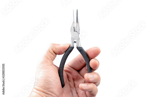Black plier in Asian male hand showing in front of white background. Clipping path. photo