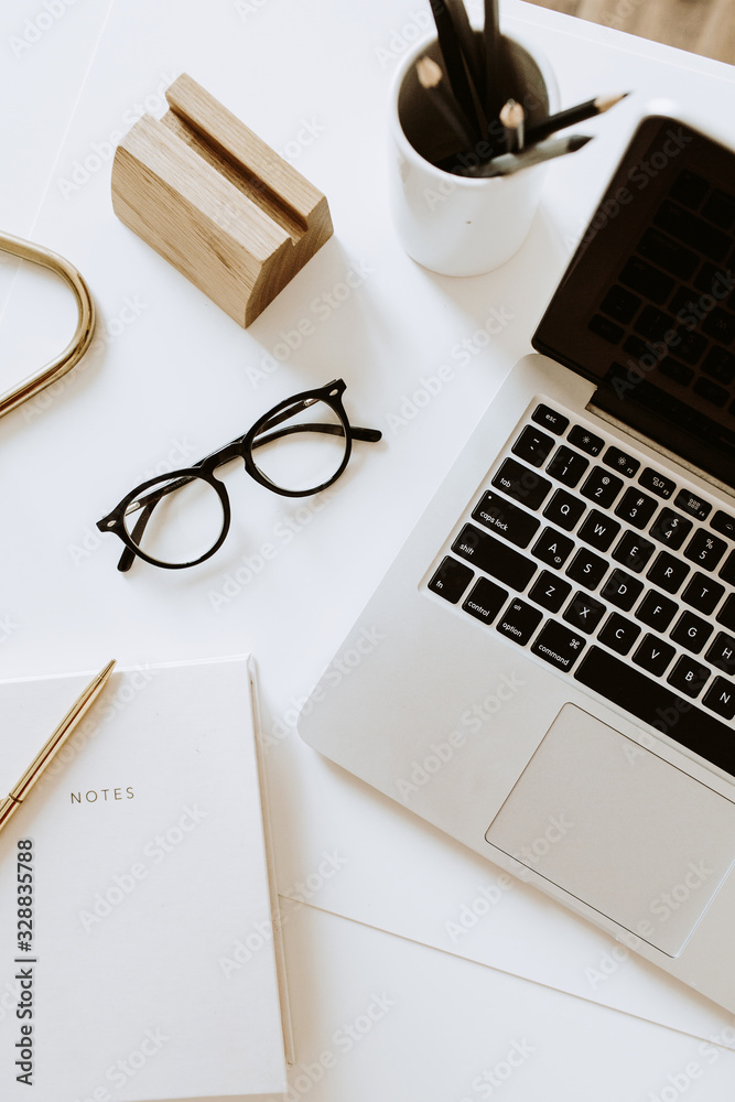 Home office desk workspace with laptop, notebook, glasses on white table. Flat lay, top view minimal women's, girl boss background. - obrazy, fototapety, plakaty 