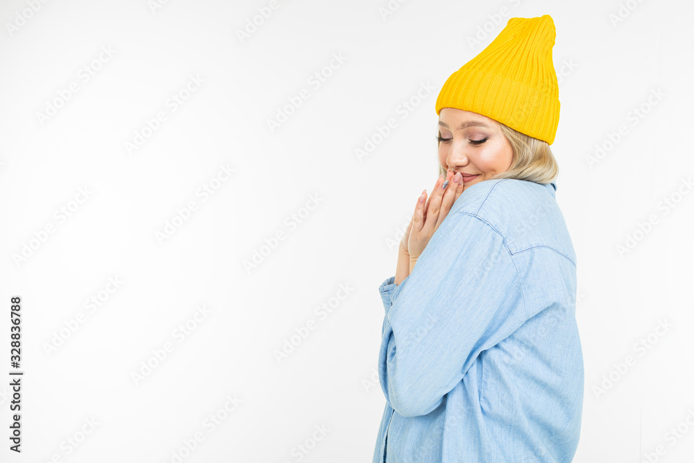 close-up of a charming blond girl in a blue denim jacket on a white background isolated with copy space close-up of a charming blond girl in a blue denim jacket on a white background isolated with copy space