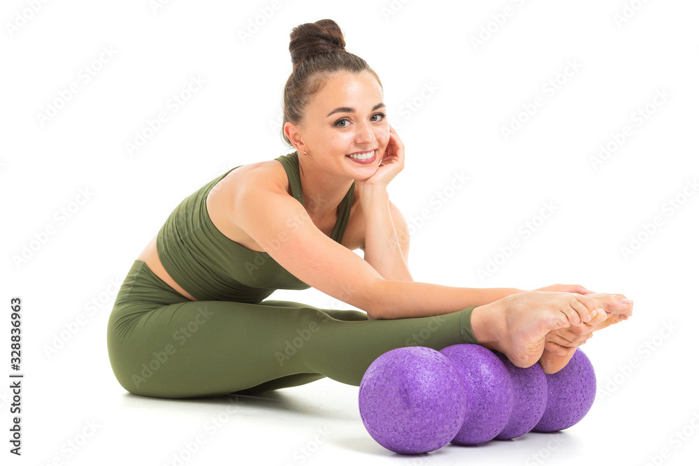 Caucasian gymnast with athletic body does warm-up, stretch muscles and smiles