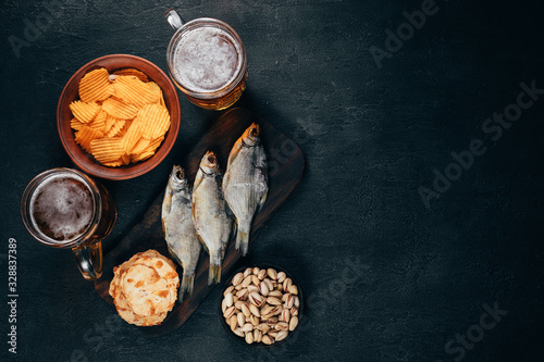 Fish and chips. Selection of appetizing snacks and two mugs of light beer. Restaurant, pub, oktoberfest food