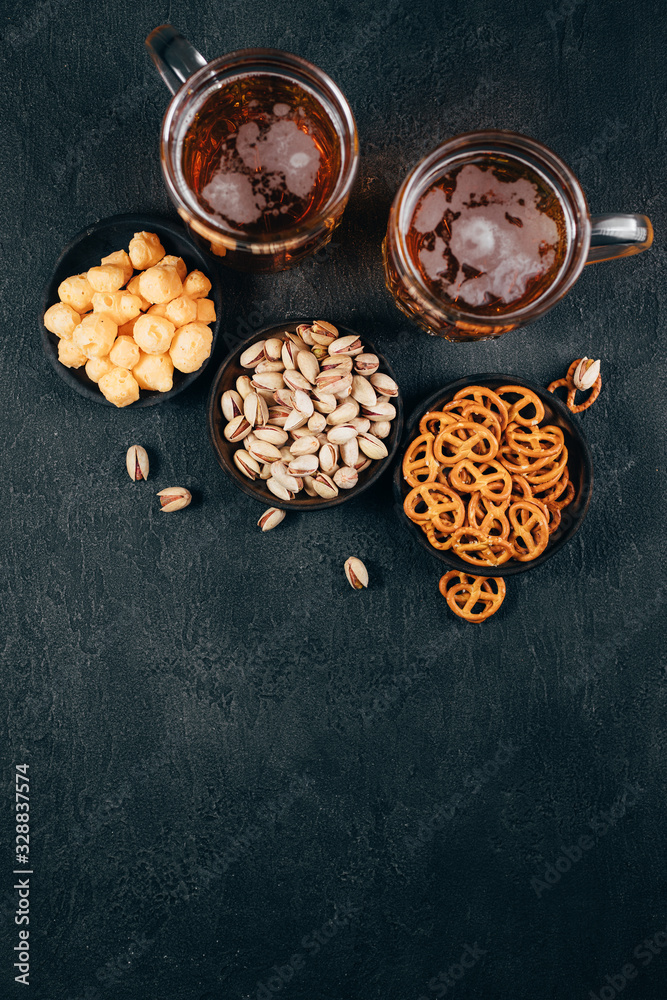 Beer, salted nuts and crunchy snacks. Oktoberfest food, pub special offer, party concept Beer, salted nuts and crunchy snacks. Oktoberfest food, pub special offer, party concept