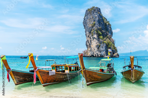 Thai traditional wooden longtail boat and beautiful sand beach at Koh Poda island in Krabi province.  Ao Nang, Thailand ,Krabi island is a most popular tourist destination in Thailand © TeTe Song