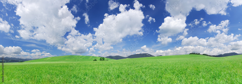 Idyllic view, green hills and blue sky with white clouds Idyllic view, green hills and blue sky with white clouds