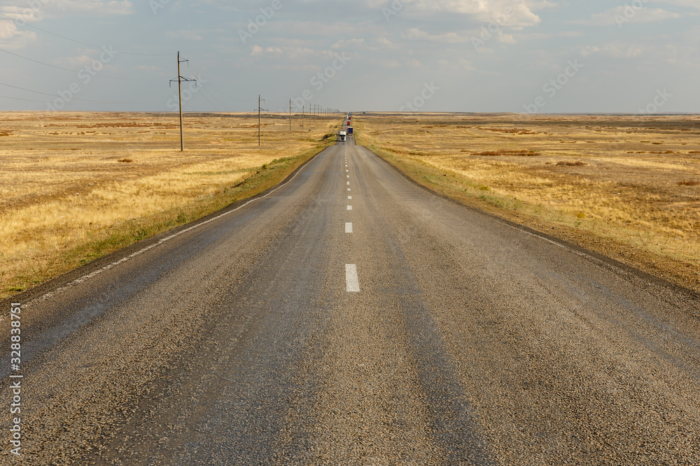 E38 highway in Ayteke Bi District of Aktobe Region in Kazakhstan, asphalt road across the steppe