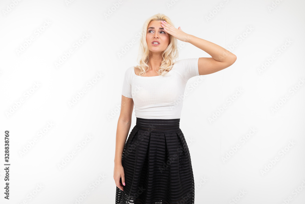 girl holding her head on a white studio background girl holding her head on a white studio background