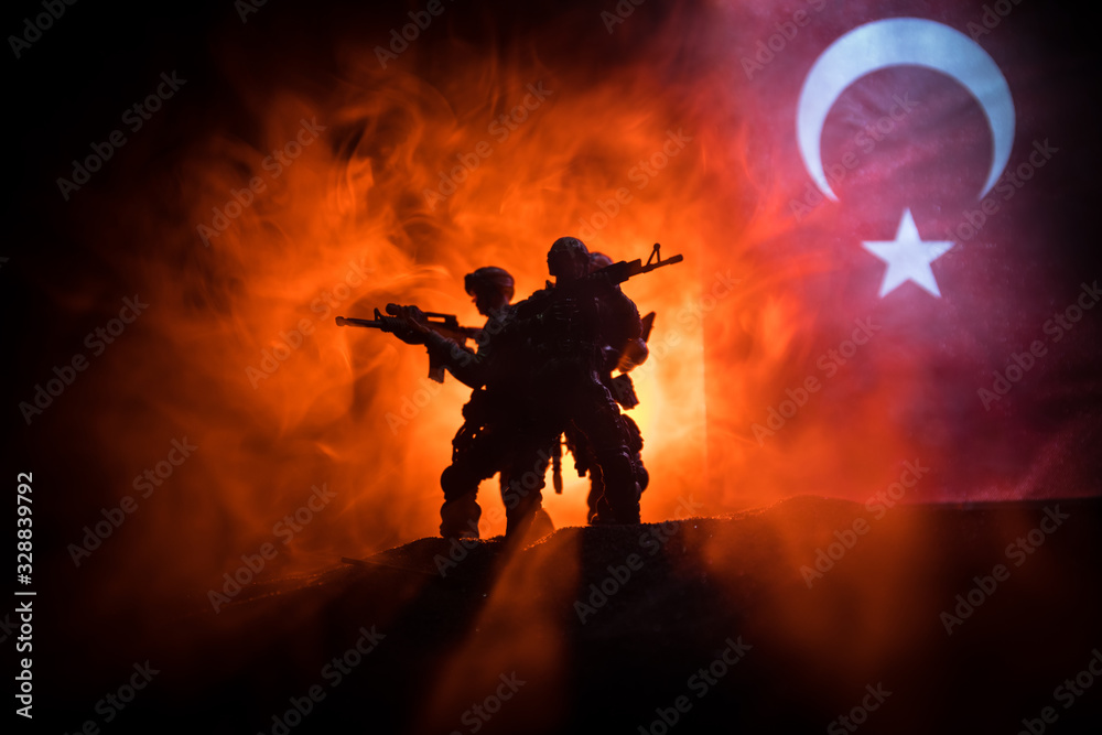 Silhouette of soldier with rifle against a turkish flag. Selective focus - obrazy, fototapety, plakaty 
