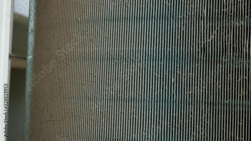 Air conditioning heat sink is dirty with dust. Scene is camera panning