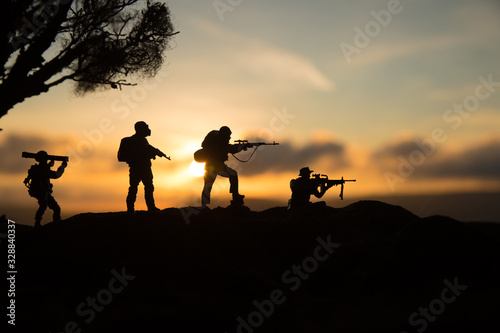 War Concept. Military silhouettes fighting scene on war fog sky background, photo