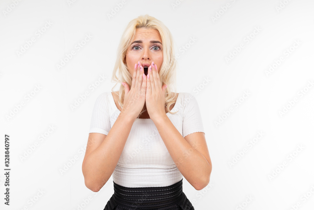 portrait of a surprised girl covering her mouth on a white background with copy space portrait of a surprised girl covering her mouth on a white background with copy space
