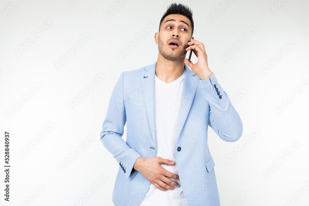 businessman in a jacket discusses important matters on the phone on a white background businessman in a jacket discusses important matters on the phone on a white background