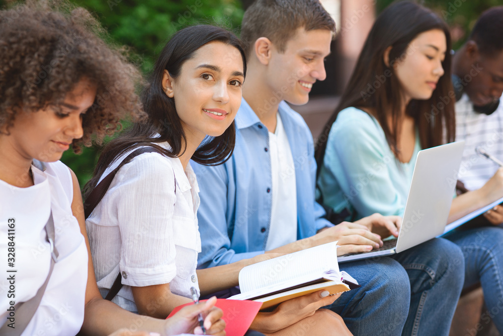 Exams Preparation. Group Of Multi-Ethnic Students Studying Together Outdoors Exams Preparation. Group Of Multi-Ethnic Students Studying Together Outdoors