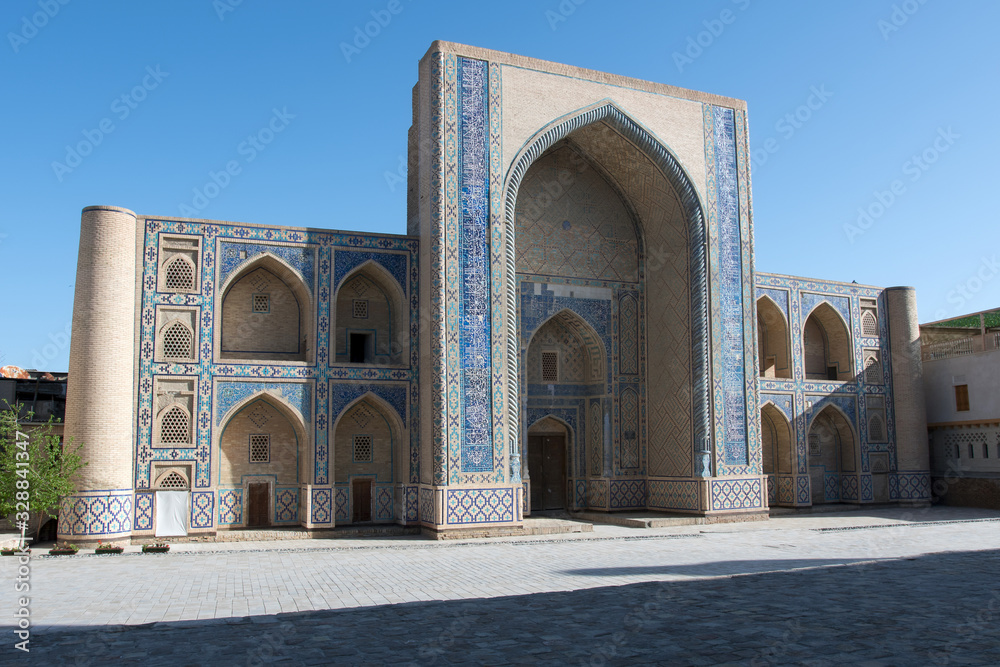 Ulugbek Madrasah on the background of blue sky. Bukhara, Uzbekistan, Central Asia.
