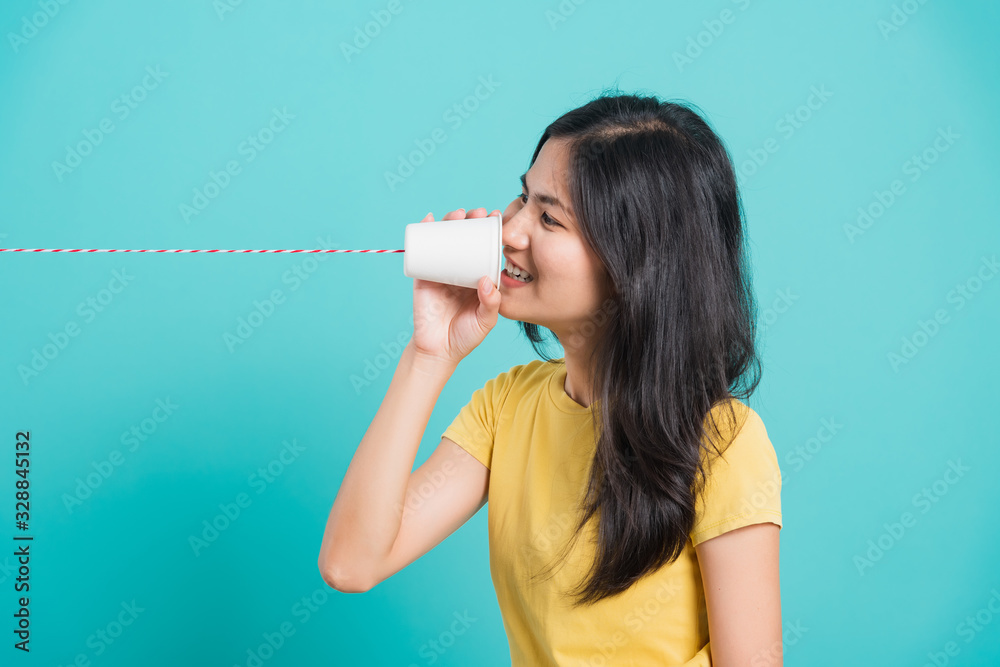 woman smile white teeth standing wear yellow t-shirt, She holding paper can telephone woman smile white teeth standing wear yellow t-shirt, She holding paper can telephone