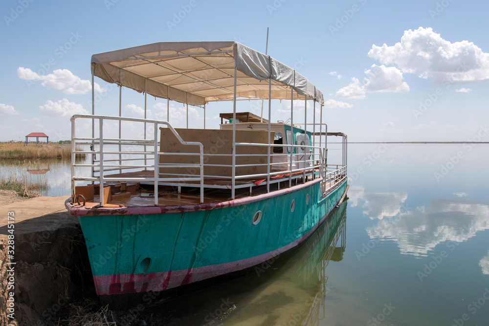 Touritic pleasure boat on Akhchakol Lake. Karakalpakstan, Uzbekistan, Central Asia.