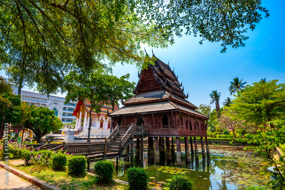 Beautiful of Tripitaka Storage Tower.Thai wooden temple architecture in the middle of pond at wat Thung Si Muang in Ubon Ratchathani province, Thailand,ASIA.