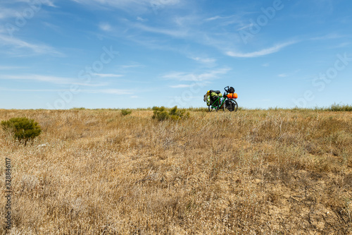a bicycle for a traveler stands in the steppe of Kazakhstan