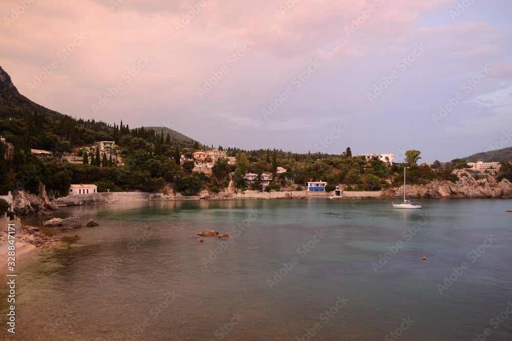 Fototapeta premium Ship in Paleokastritsa bay in sunset - Platakia Beach