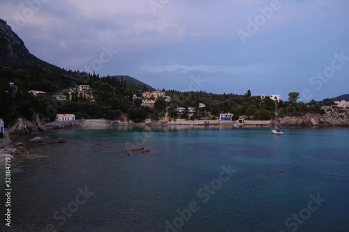 Paleokastritsa bay. Ship in Paleokastritsa bay in sunset - Platakia Beach