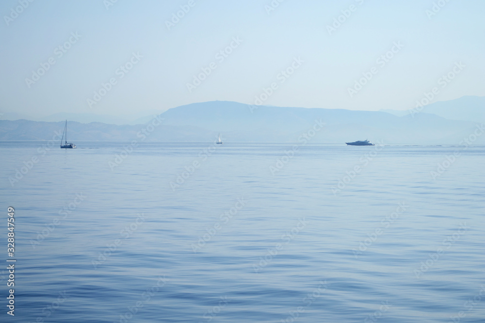 Boats on the sea. Landscape with boats at horizon in a summer day.