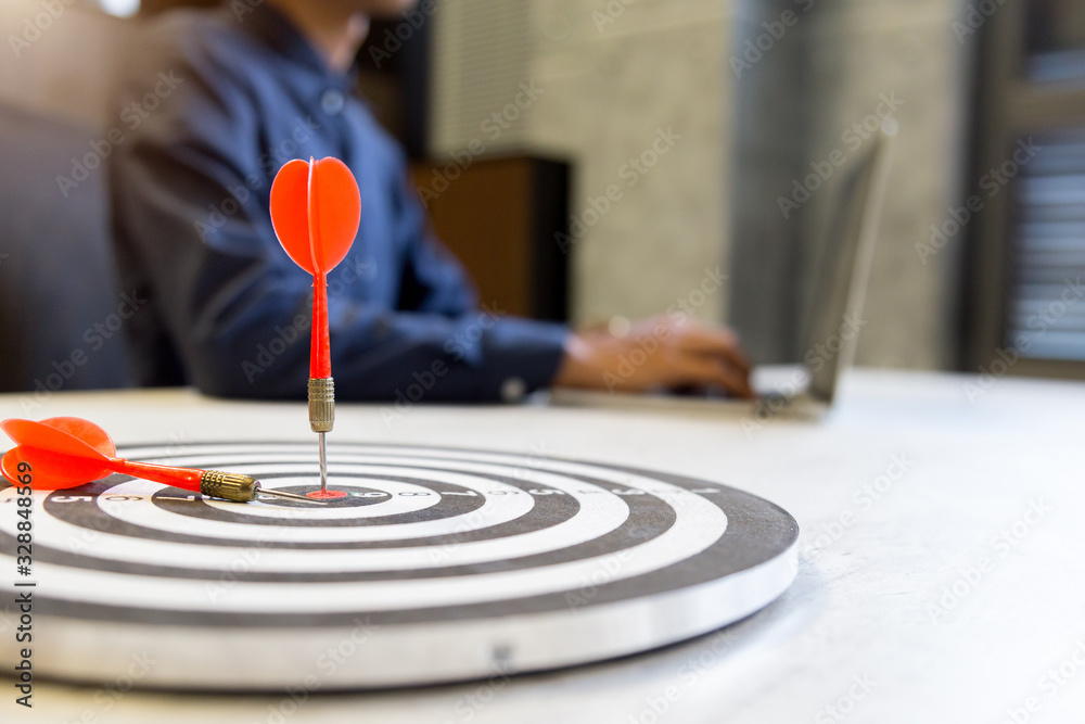 Red dart arrow hitting in the target center of dartboard on bullseye,business growth success concept. Red dart arrow hitting in the target center of dartboard on bullseye,business growth success concept.