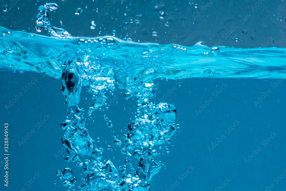 Surface of blue water against white background. Surface of blue water against white background.