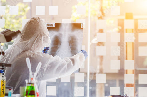 The medical team wore a coronavirus protective suit and rubber gloves to examine the coronavirus covid-19 and research for a vaccine to prevent coronavirus covid-19 to stop the epidemic. photo