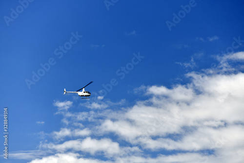 big tourist helicopter against the blue sky in the area of the Christ monument on the observation deck © константин константи