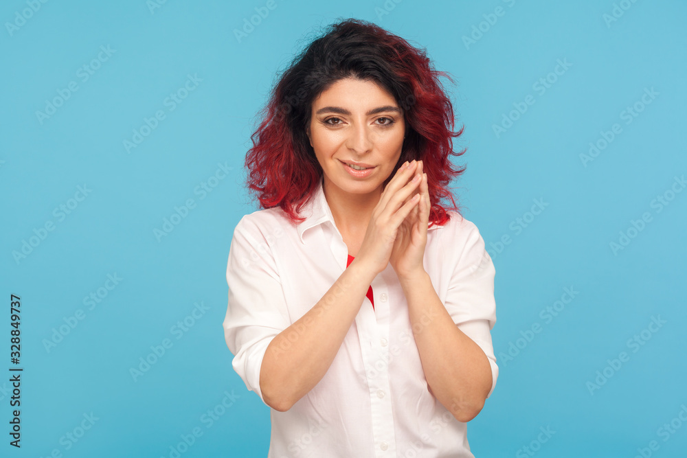 Distrustful sneaky hipster woman with fancy red hair in white shirt thinking cunning idea to prank friend, having tricky plan in mind, scheming revenge. indoor studio shot isolated on blue background Distrustful sneaky hipster woman with fancy red hair in white shirt thinking cunning idea to prank friend, having tricky plan in mind, scheming revenge. indoor studio shot isolated on blue background