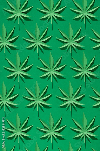 Cannabis leaf made of paper on green background