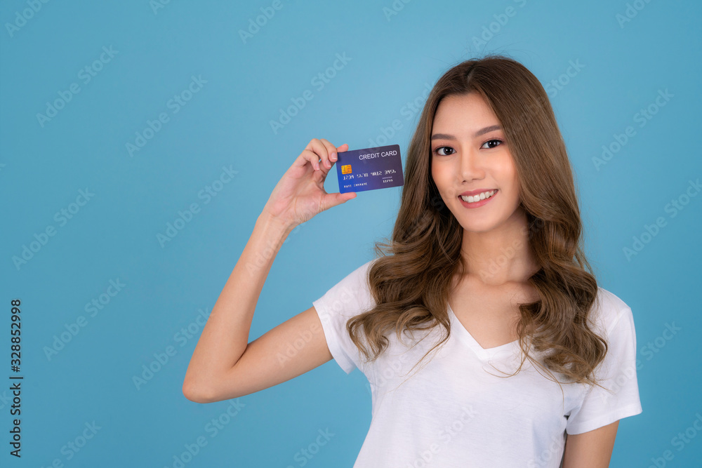Portrait of a lovely asian young girl in white T Shirt showing credit card Portrait of a lovely asian young girl in white T Shirt showing credit card