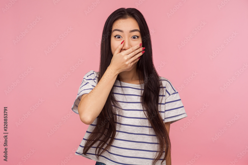Omg, I won't say anything! Portrait of shocked girl in striped t-shirt closing mouth and looking with scared eyes, intimidated victim afraid to tell truth. studio shot isolated on pink background Omg, I won't say anything! Portrait of shocked girl in striped t-shirt closing mouth and looking with scared eyes, intimidated victim afraid to tell truth. studio shot isolated on pink background