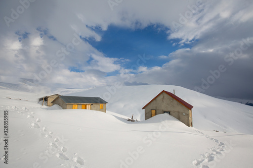 chalets on the highland covered with snow in rize turkey