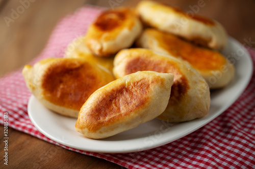 Pirozhki - small pie with meat on plate