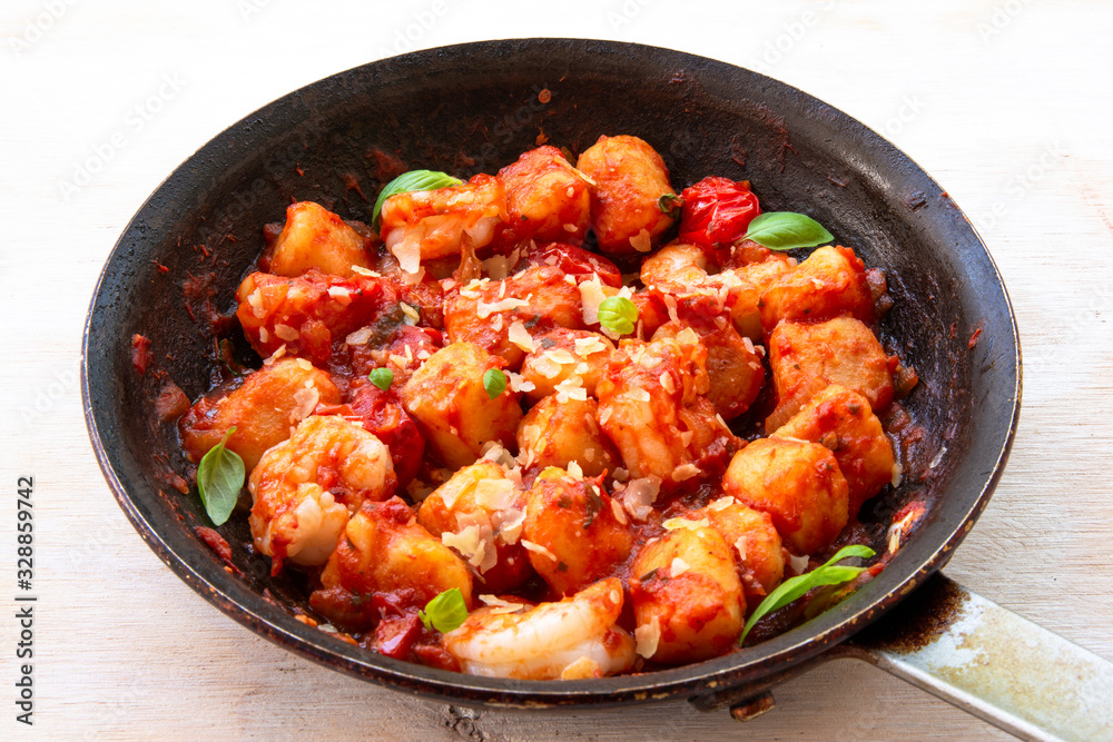 Gnocchi with tomato sauce and garnshied basil and cheese Gnocchi with tomato sauce and garnshied basil and cheese