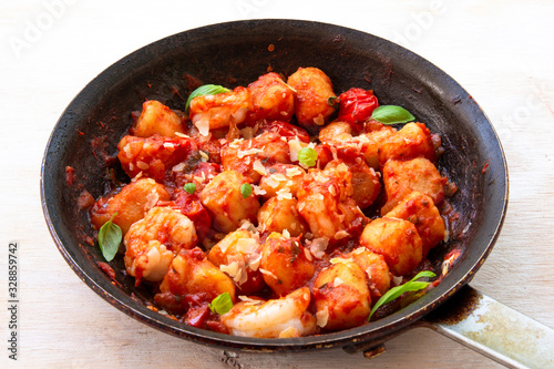 Gnocchi with tomato sauce and garnshied basil and cheese