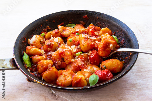 Gnocchi with tomato sauce and garnshied basil and cheese