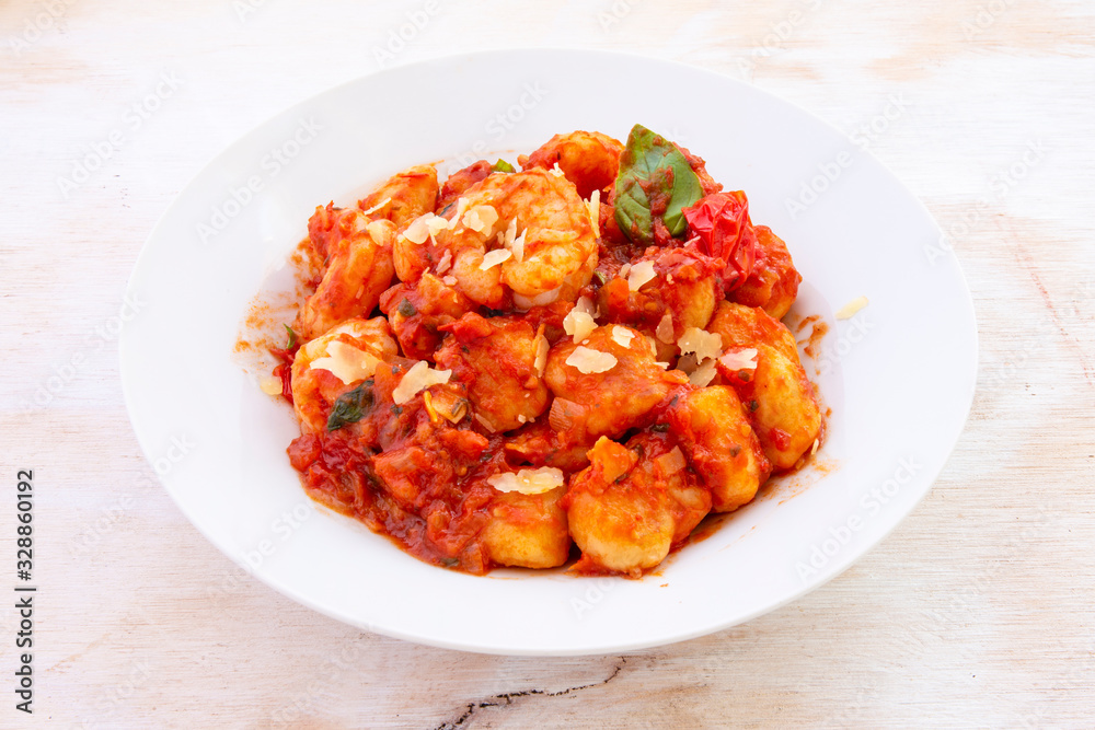 Gnocchi with tomato sauce and garnshied basil and cheese Gnocchi with tomato sauce and garnshied basil and cheese