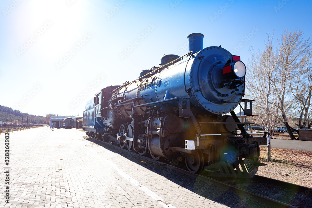 Naklejka premium Front view of old steam iron big locomotive on the station in Arizona, USA