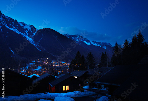View of Chamonix village and Le Brevent mountain during the night evening time, Auvergne-Rhone-Alpes region in south-eastern France