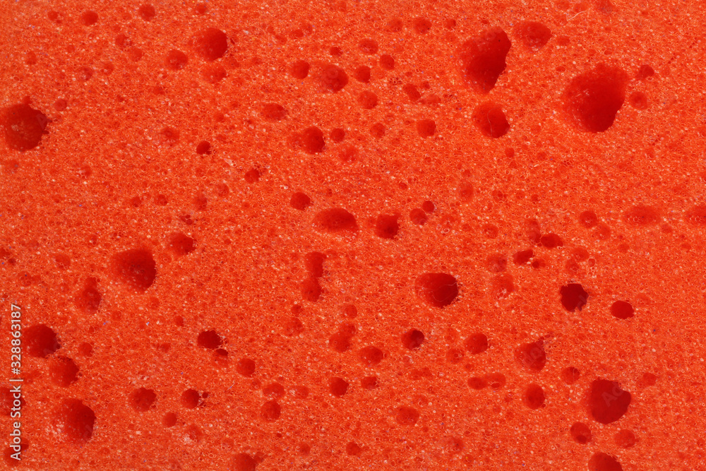 Texture, background of a red sponge for washing dishes or showering close up, macro Texture, background of a red sponge for washing dishes or showering close up, macro