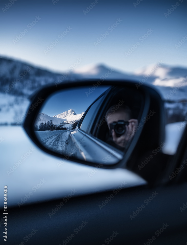Photography in the rearview mirror. Travel by car in the mountains. Landscape in winter. Norway - travel