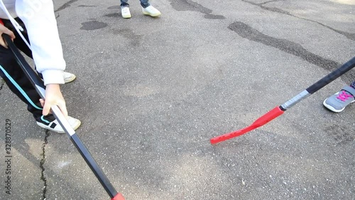 children are playing hockey on the street