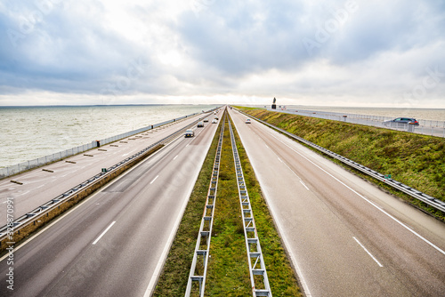 Den Oever, Netherlands - January 09, 2020. Highway between two sees on the north of Netherlands splitting IJsselmeer and Waddeneilanden (Frisian Islands) photo